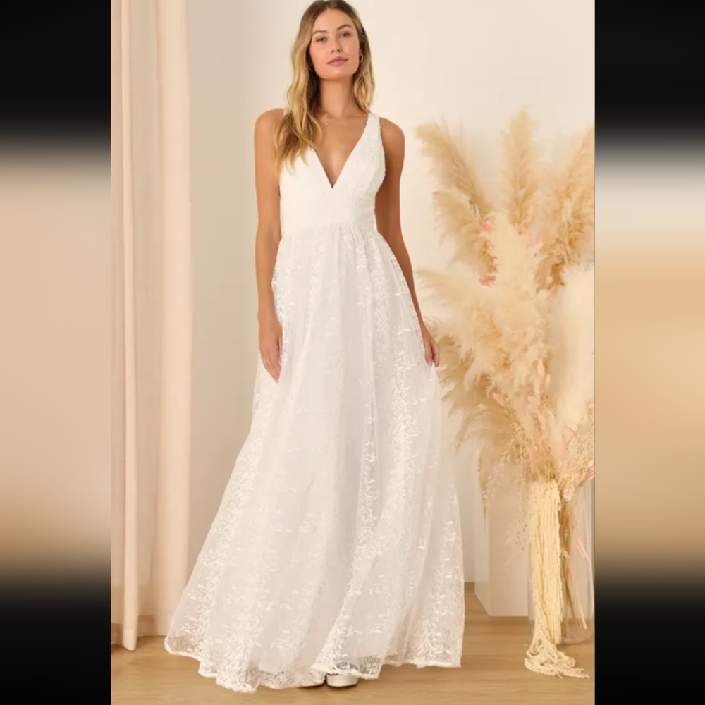 White sleeveless wedding dress with plunging V-neckline and flowing skirt